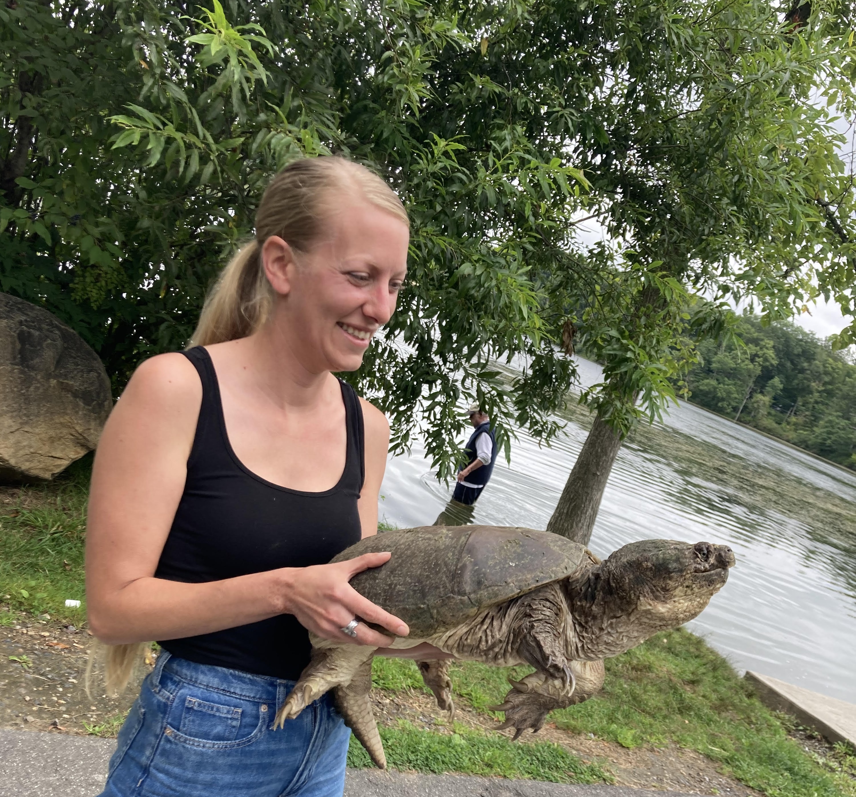 Tracy holding Enki before releasing him into Lake Mansfield